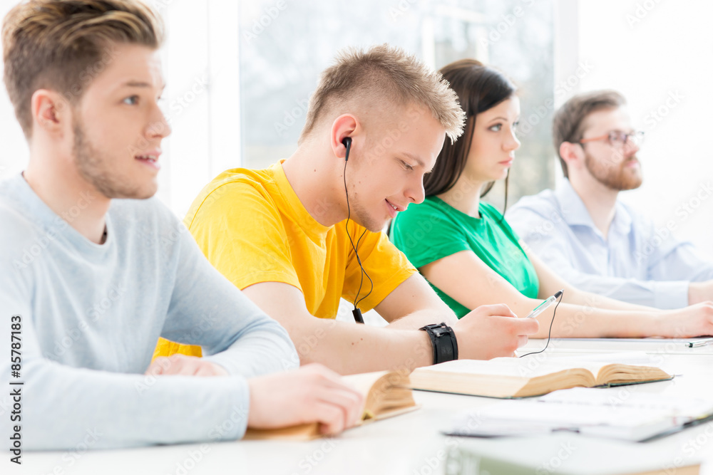 Young and smart students learning in a classroom