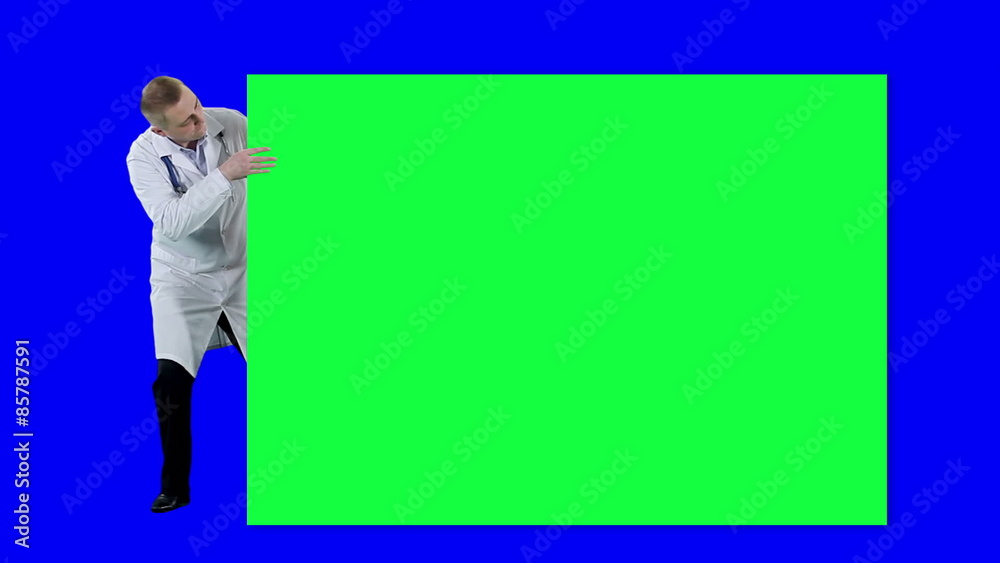 Doctor peeks out from behind the poster. Chroma key background. Medic in a white coat steps out from behind the poster
Doctor peeks out from behind the poster. Chroma key background. Medic in a white coat steps out from behind the poster