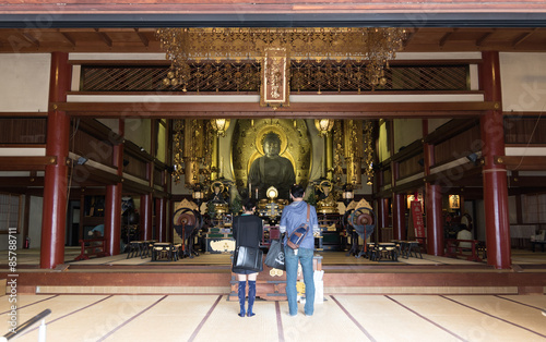A couple at a Buddhist Shrine in the Kyoto Shopping Arcade