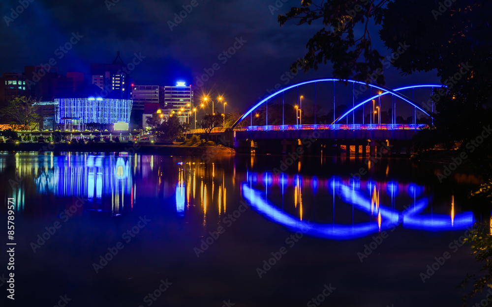 lake side bridge with city lights
