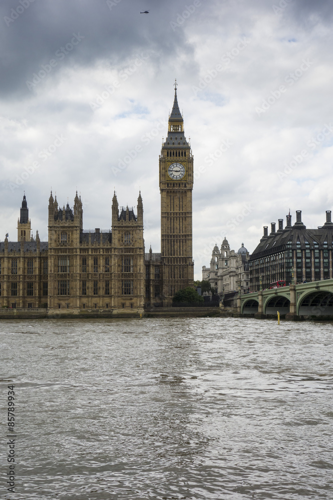 Big Ben, Houses of Parliament and the River Thames on a grey cloudy day London England Big Ben, Houses of Parliament and the River Thames on a grey cloudy day London England