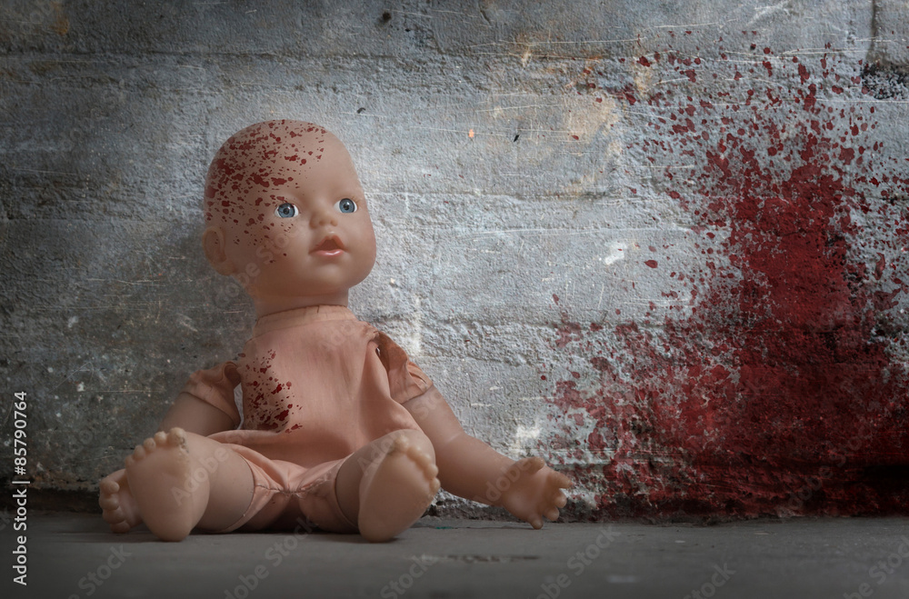 Concept of child abuse - Bloody doll