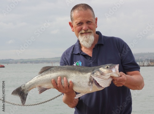 A fisherman with his rod caught specimen seabass of 9lb 11oz