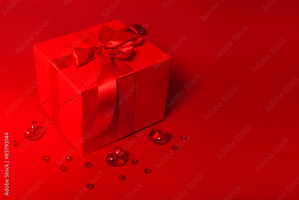 Cute red gift box on the red background