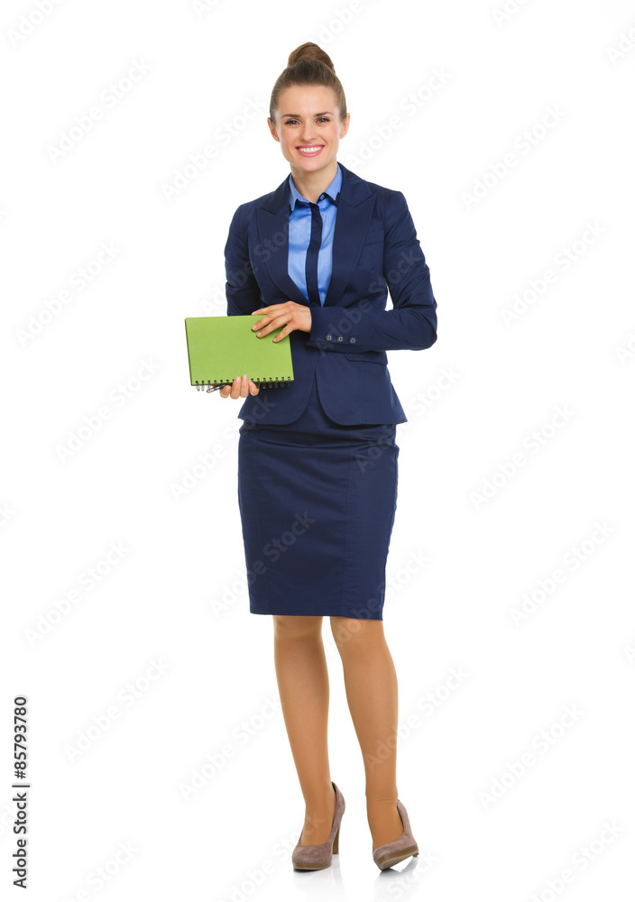 Elegant business woman standing and holding notebook Elegant business woman standing and holding notebook
