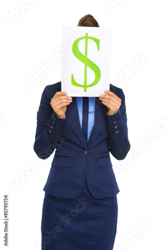 Businesswoman holding dollar sign in front of face