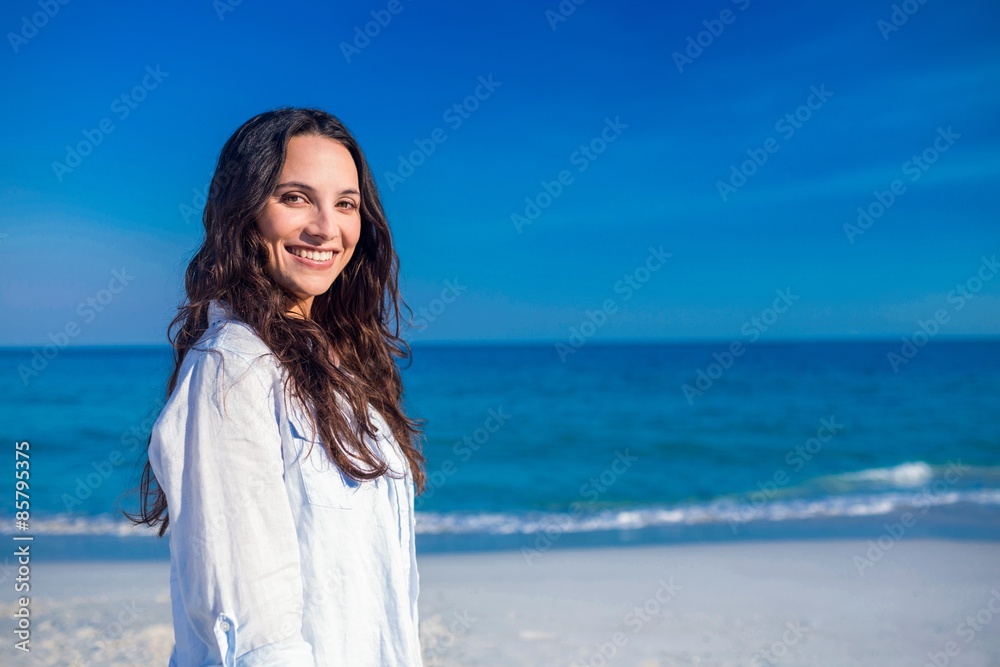 Smiling woman looking at camera at the beach Smiling woman looking at camera at the beach