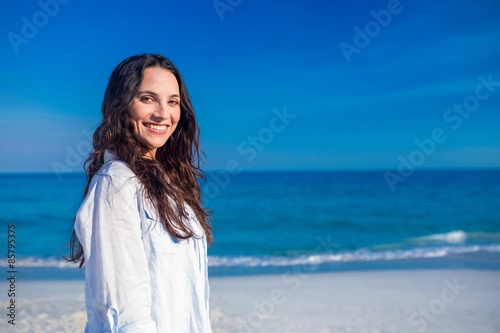 Smiling woman looking at camera at the beach 