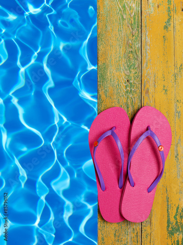 Slippers by the pool side © goir