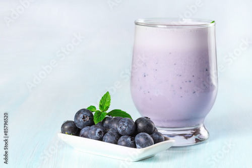 Milk cocktail with ripe blueberries.