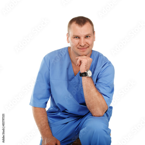 Portrait of a young male doctor in a medical surgical blue unifo photo