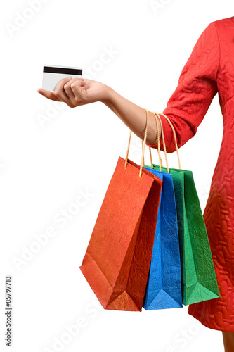 Woman with a gift bag and a credit card on a white background