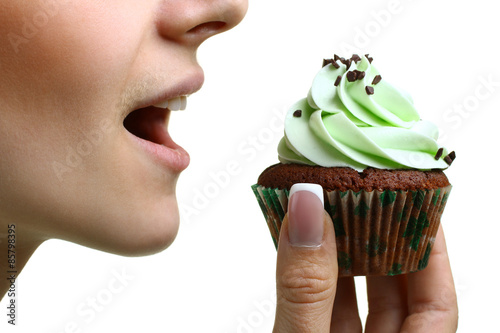 Canvas Print closeup of woman eating chocolate cupcake