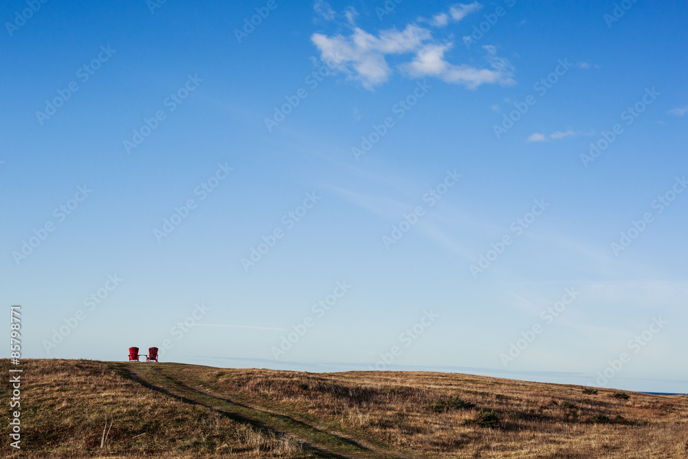 Lonely Red Chairs beneath a Big Blue Sky Lonely Red Chairs beneath a Big Blue Sky