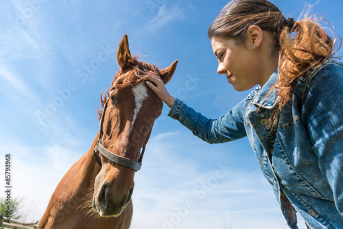 Young brunette woman and her horse