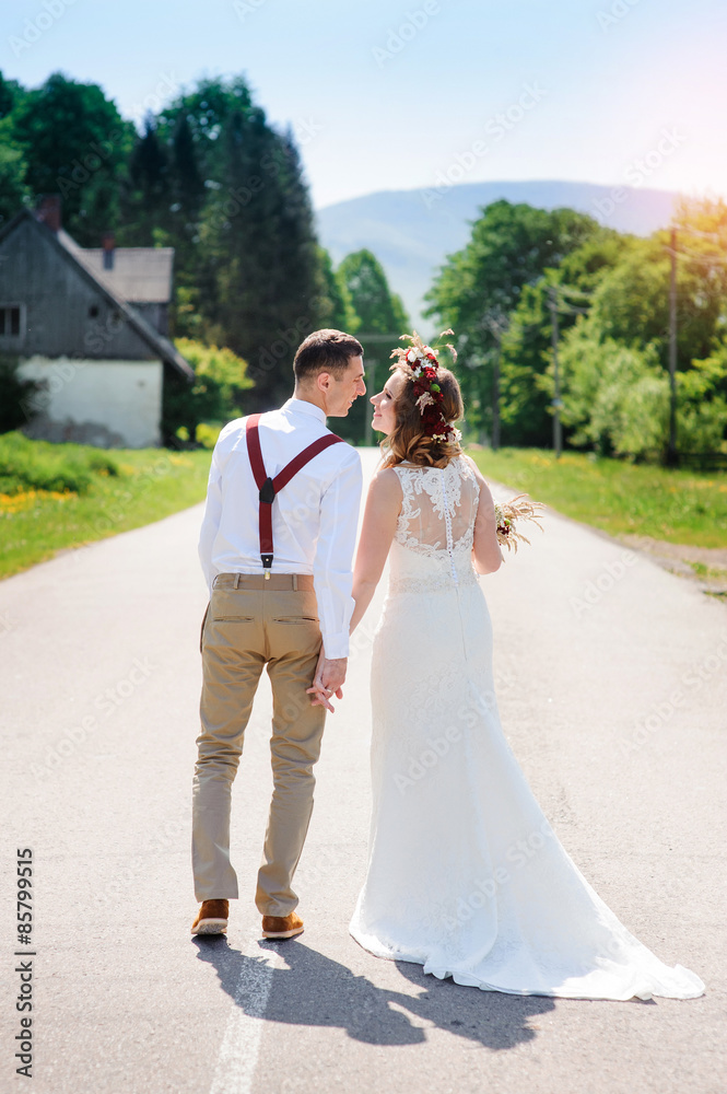 bride and groom walking on the road bride and groom walking on the road