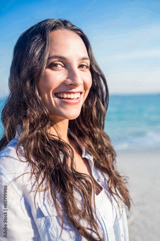 Smiling woman looking at camera at the beach Smiling woman looking at camera at the beach