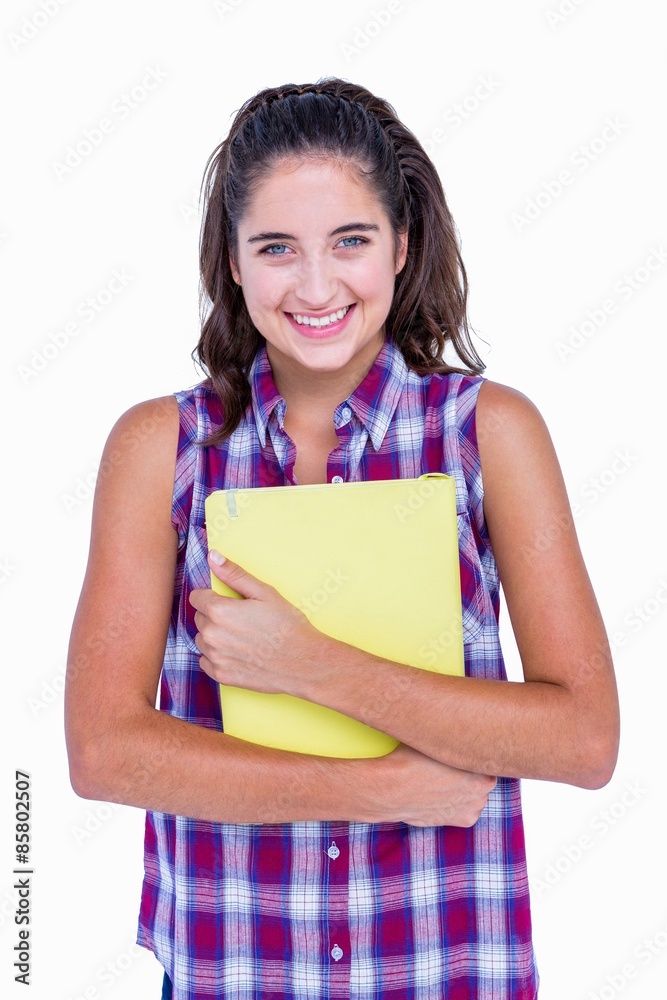 Pretty brunette looking at camera and holding notebook Pretty brunette looking at camera and holding notebook
