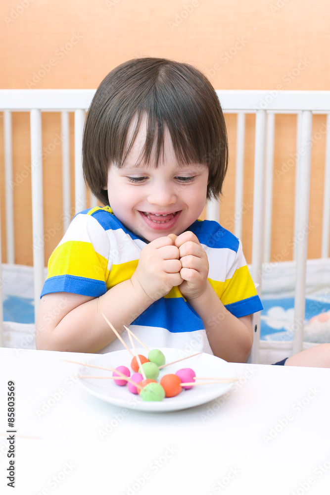 Happy child with lollipops of playdough and toothpicks Happy child with lollipops of playdough and toothpicks