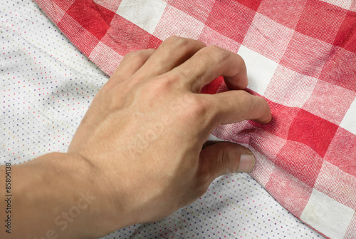 hand touching fabric