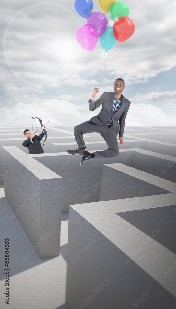Composite image of businessman shooting a bow and arrow Composite image of businessman shooting a bow and arrow