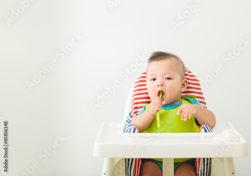 baby child eating in chair
