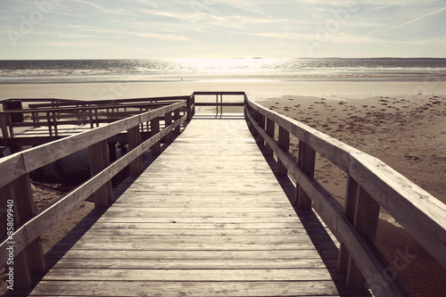 boardwalk to sandy beach and ocean with instagram filter effect © nickjene