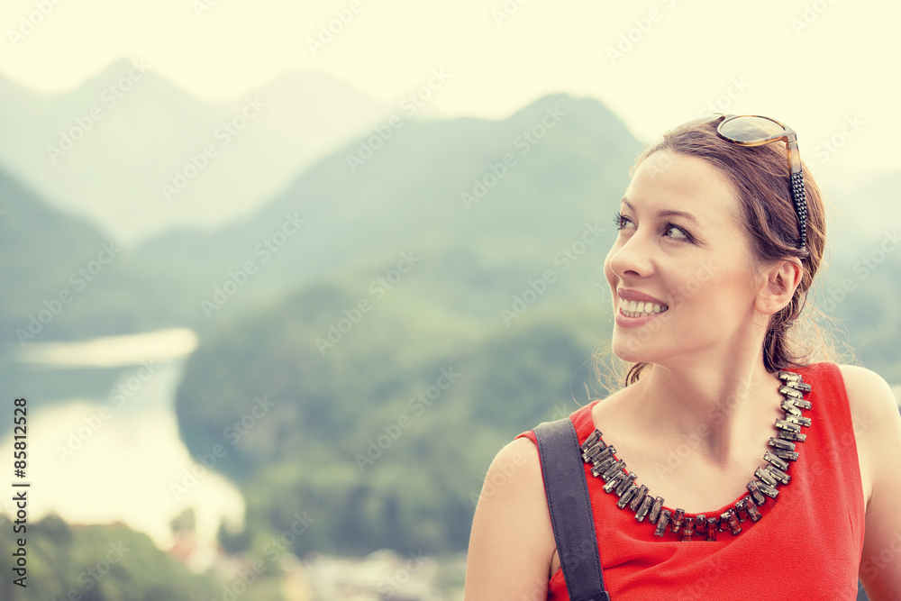 Closeup happy woman with Bavarian Alps Germany at sunset background Closeup happy woman with Bavarian Alps Germany at sunset background