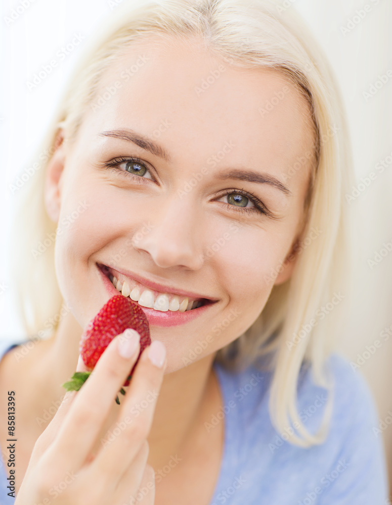 happy woman eating strawberry at home happy woman eating strawberry at home