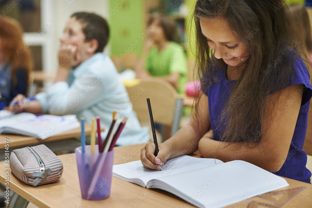 Girl drawing in her notebook Girl drawing in her notebook