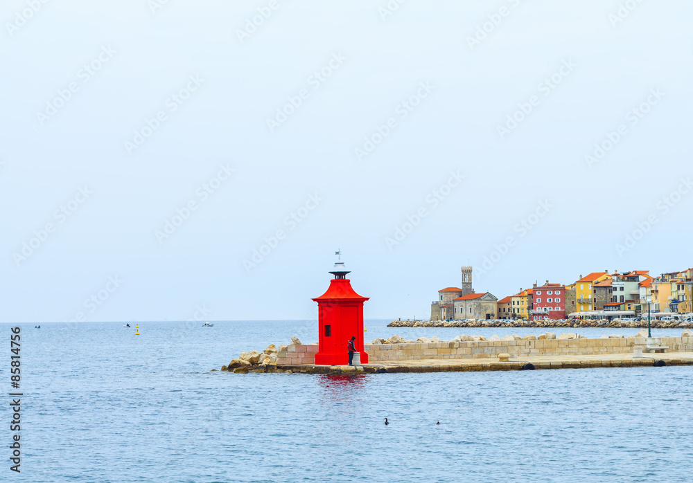 View of red light house and city of Piran on back ground, Slovenia.