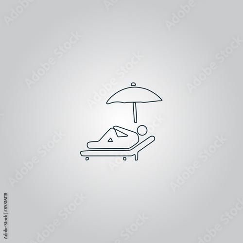 relax under an umbrella on a lounger