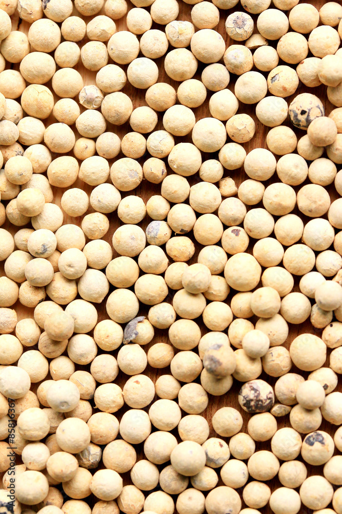 white pepper seeds on wooden background. white pepper seeds on wooden background.