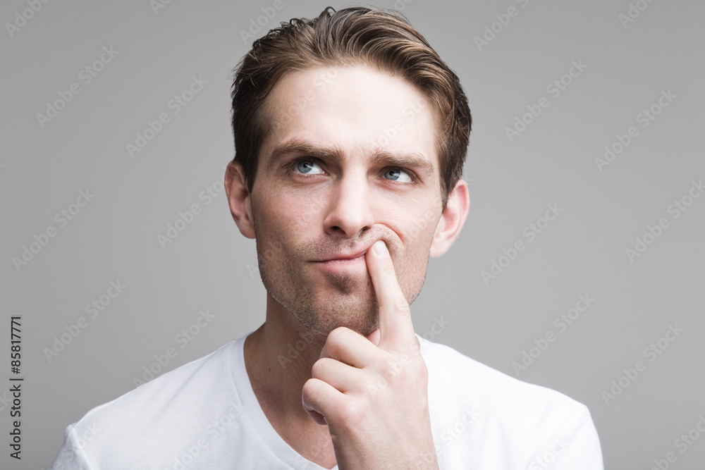 Thoughtful guy in a white T-shirt Thoughtful guy in a white T-shirt