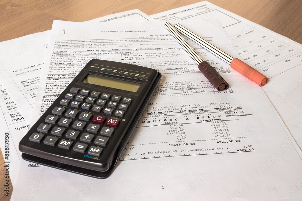 Business composition of bills, calculator, pen and various statistics Business composition of bills, calculator, pen and various statistics