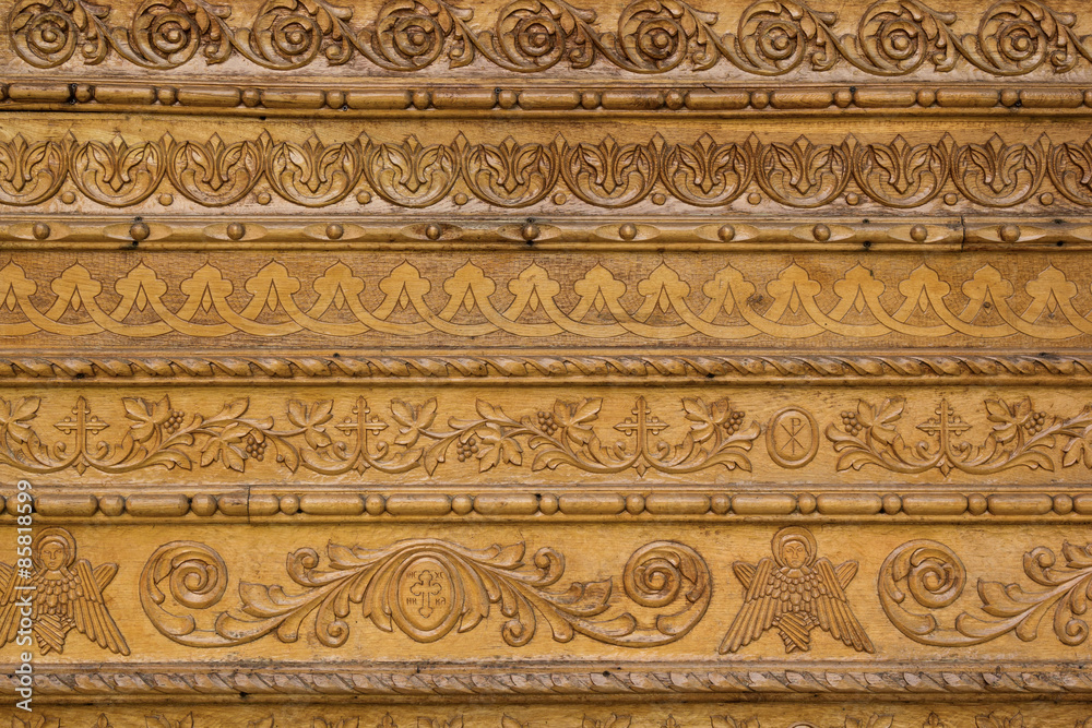 Close up ornamental wood  carvings on the wall of monasteries in