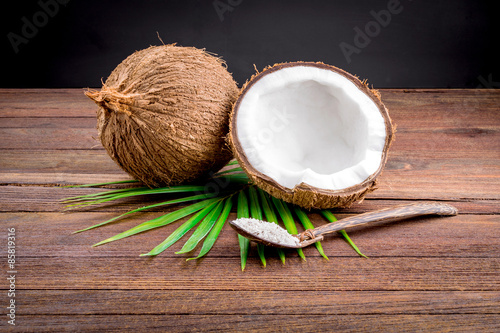 Close up of a coconut and grounded coconut flakes