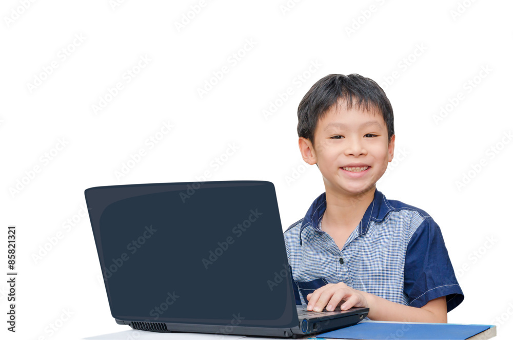 Little Asian boy using notebook computer over white Little Asian boy using notebook computer over white