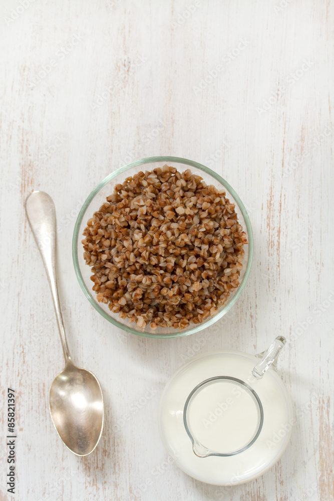 buckwheat in bowl with milk and spoon buckwheat in bowl with milk and spoon