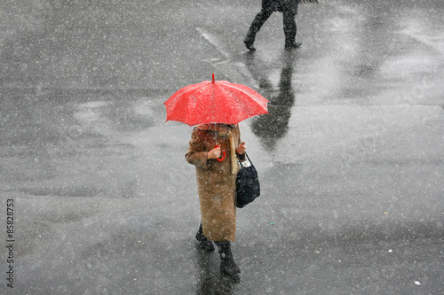 Girl with umbrella during snow storm