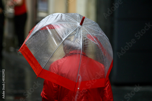Woman with umbrella walking in rain
