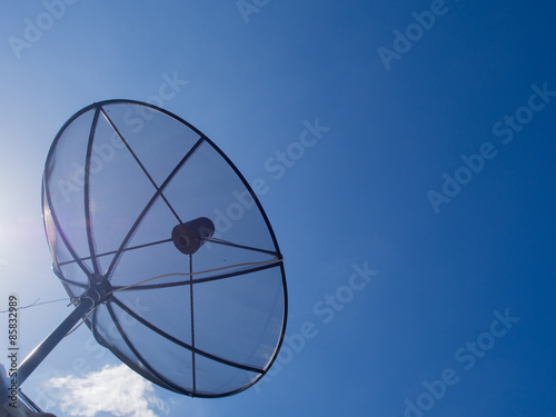 Satellite dish transmission data on bright blue sky background.Satellite dish communication technology network.