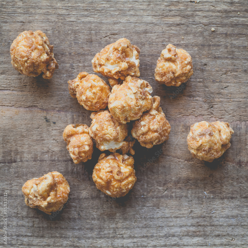 Almond and caramal popcorn on wood background Almond and caramal popcorn on wood background