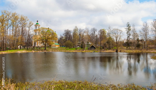Rural spring landscape with a temple and the lake