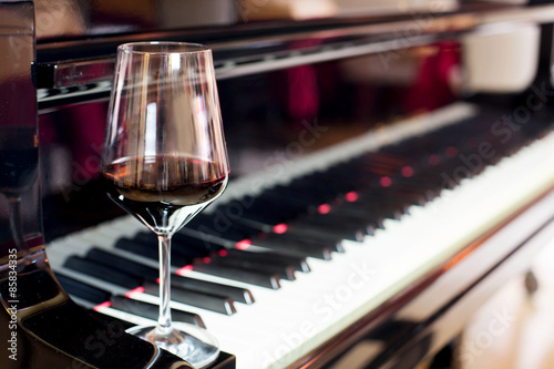 red wine glass and piano