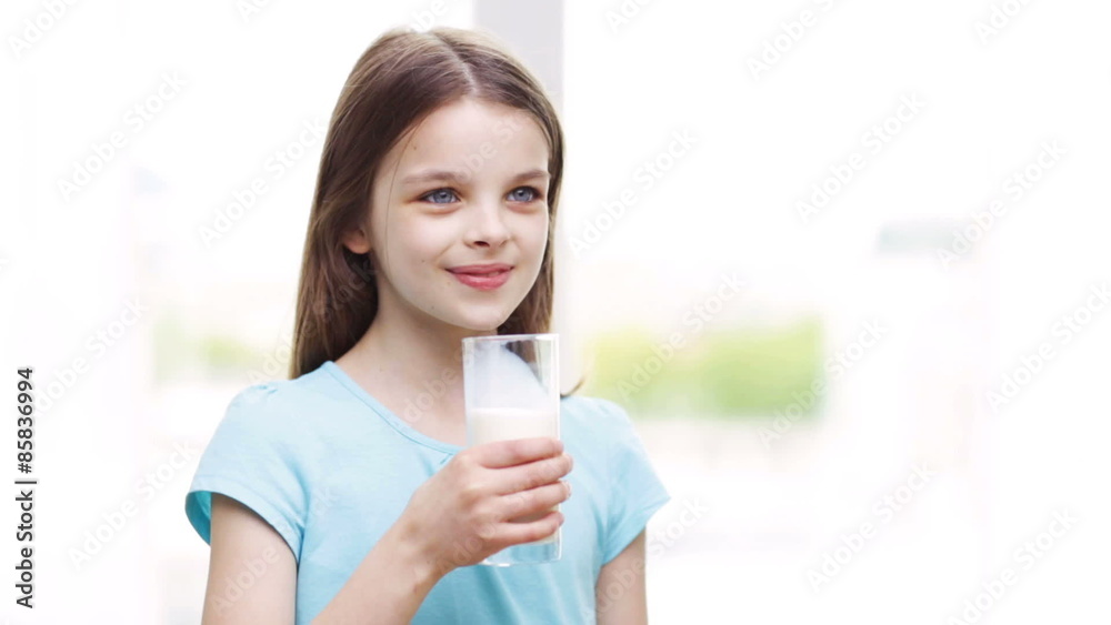happy smiling little girl drinking milk at home happy smiling little girl drinking milk at home