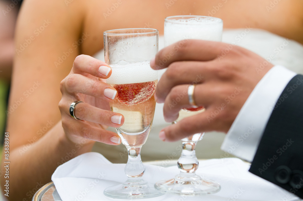two hands holding a champagne glass