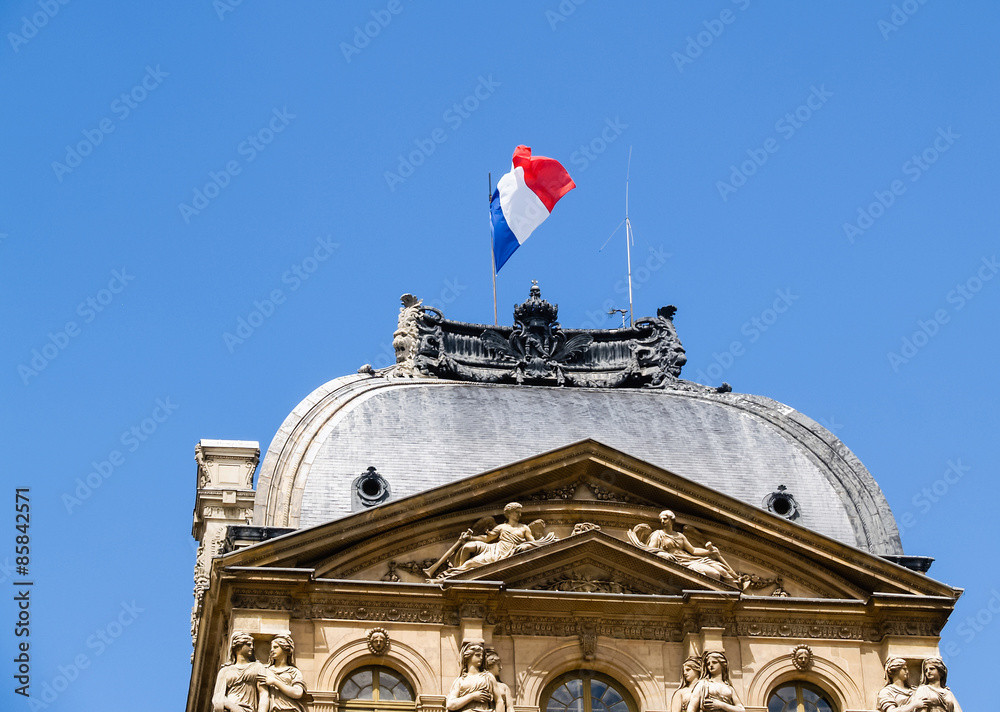 Obraz premium Flag of France over historic building.