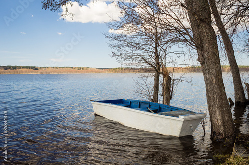 Wooden boat on the lake in the spring