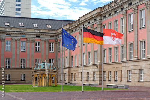 The flags of European Union, Germany and Brandenburg in front of Landtag Brandenburg in Potsdam, Germany